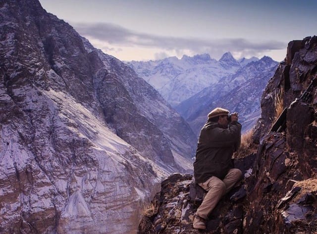 This shows how incredibly treacherous the Himalayan Mountains are. Here's a picture of a guide checking for ibex on a near vertical cliff.
